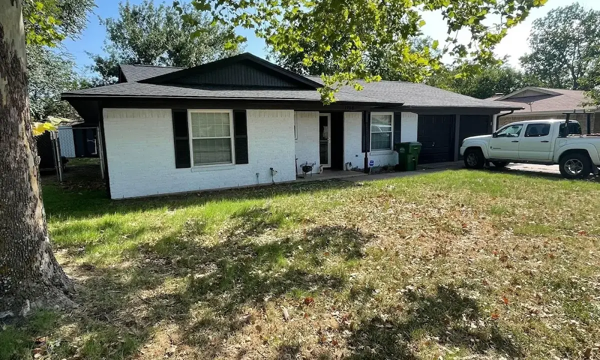Professional roofing crew working on a residential roof in Dickinson